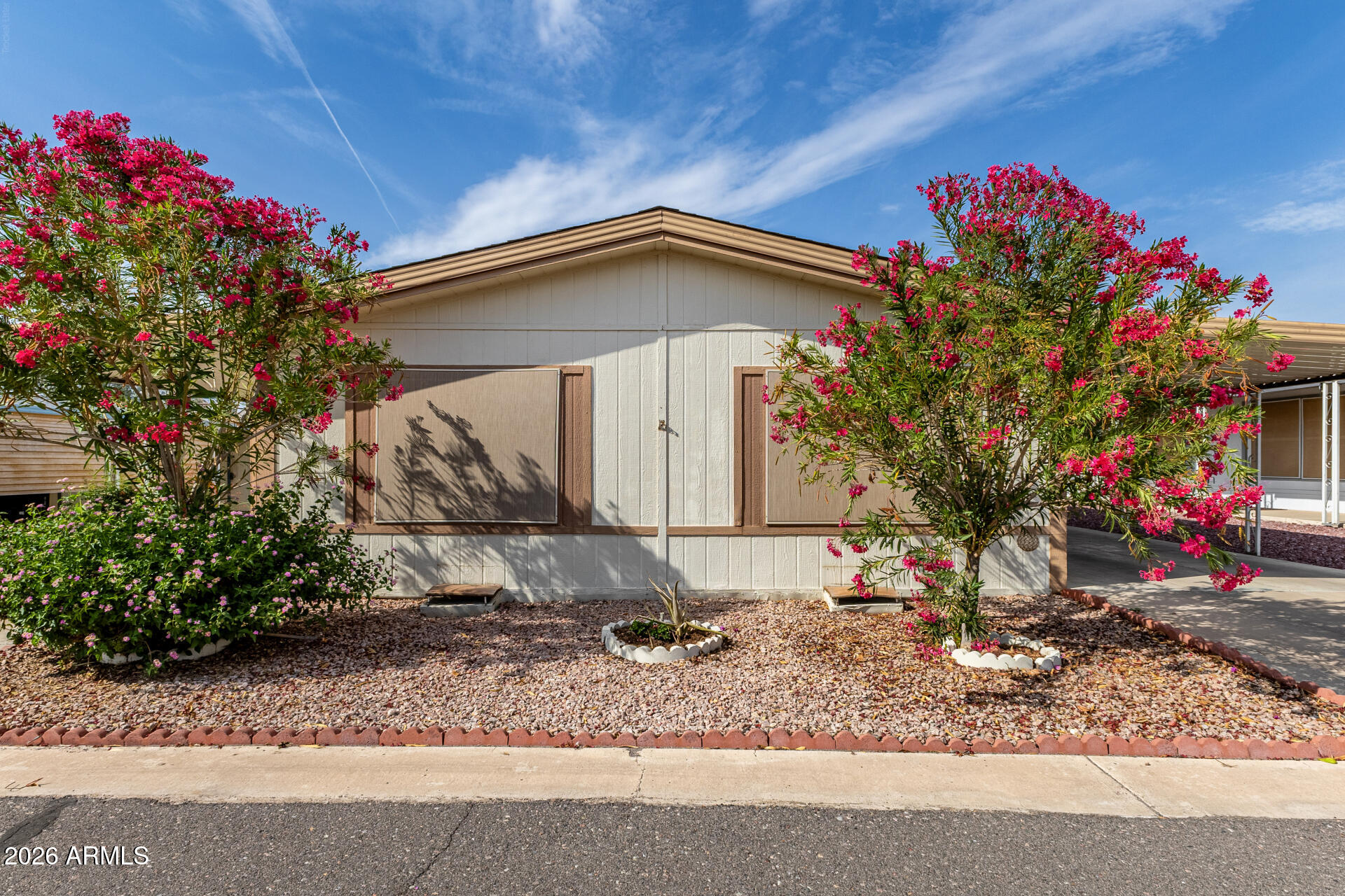 3330 East Main Street, Unit 448 Mesa, AZ 85213 - Photo 2 of 30 a front view of a house with a yard