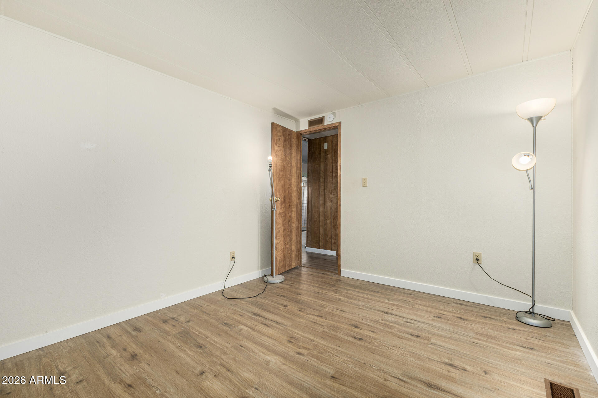 3330 East Main Street, Unit 448 Mesa, AZ 85213 - Photo 21 of 30 a view of an empty room with wooden floor