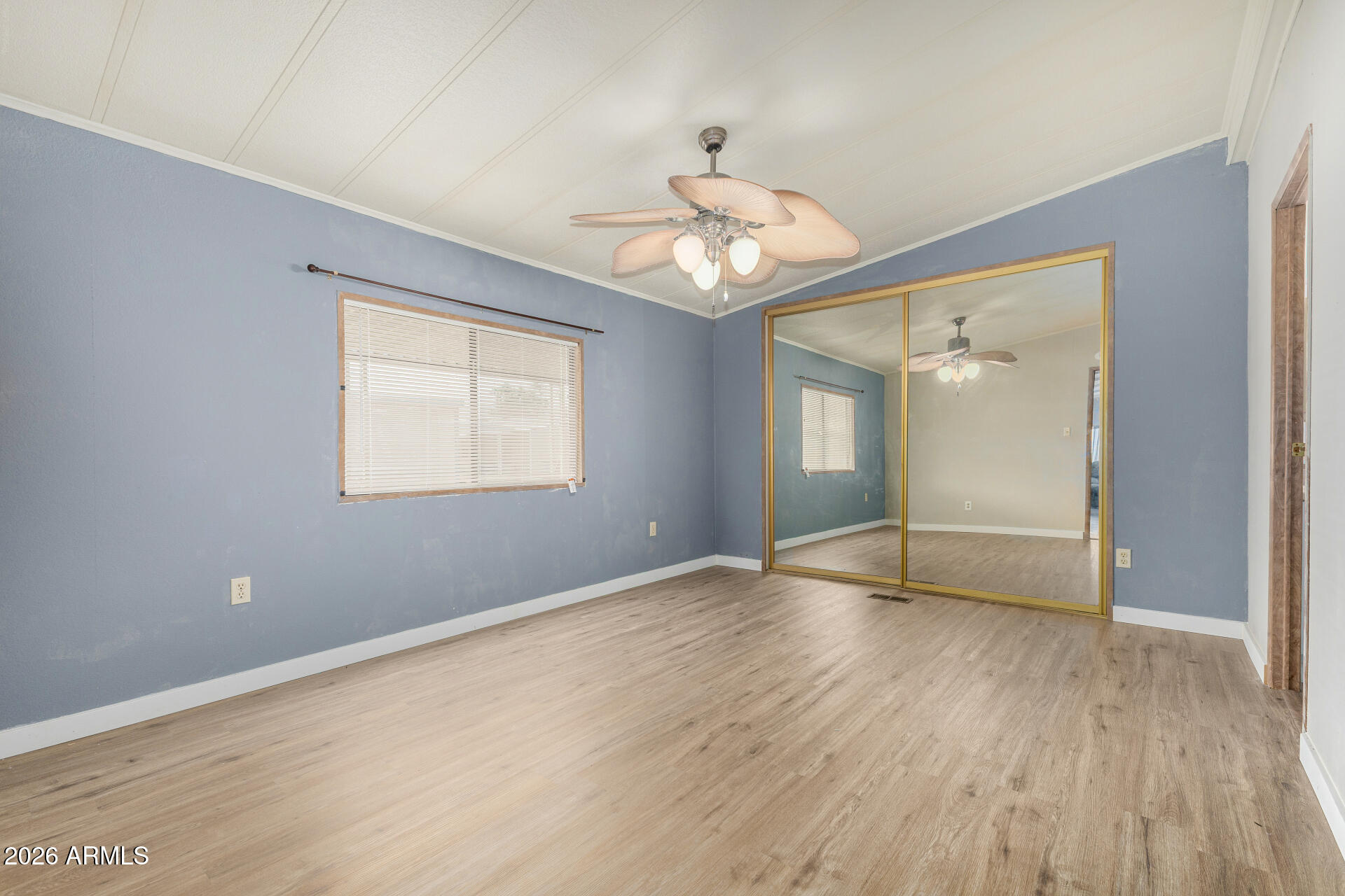 3330 East Main Street, Unit 448 Mesa, AZ 85213 - Photo 22 of 30 a view of an empty room with wooden floor and a window