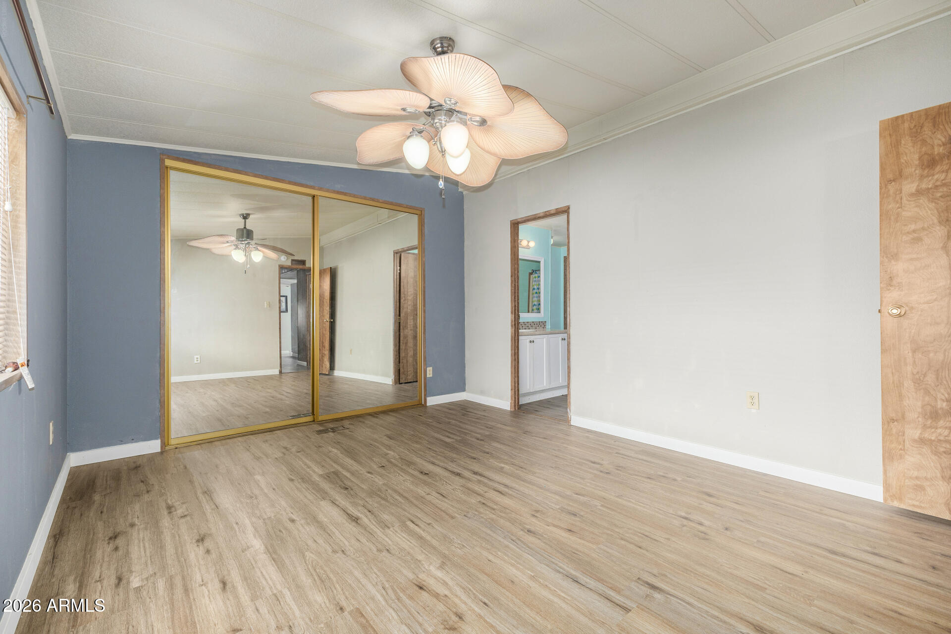 3330 East Main Street, Unit 448 Mesa, AZ 85213 - Photo 23 of 30 a view of an empty room with wooden floor and a window
