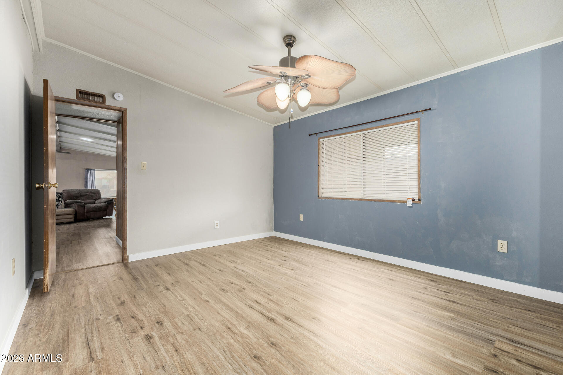 3330 East Main Street, Unit 448 Mesa, AZ 85213 - Photo 25 of 30 a view of empty room with wooden floor and fan