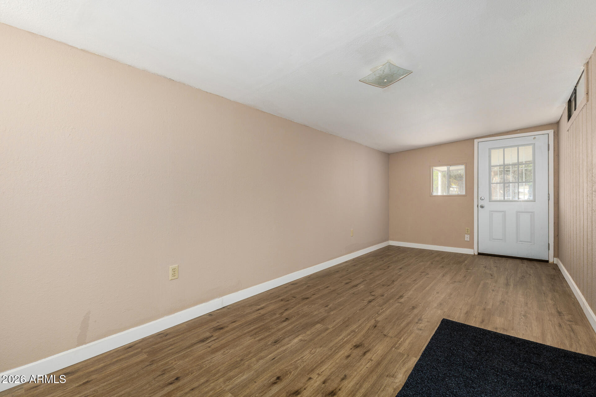 3330 East Main Street, Unit 448 Mesa, AZ 85213 - Photo 7 of 30 an empty room with wooden floor and windows