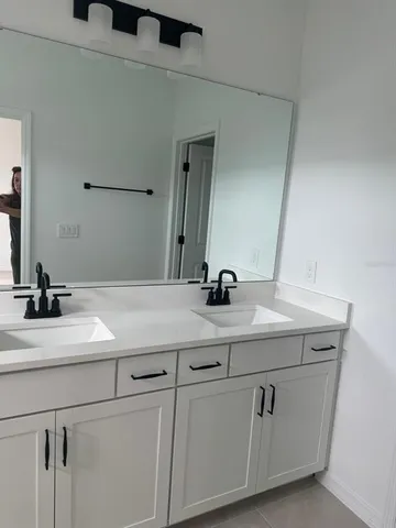 a bathroom with a sink and a mirror