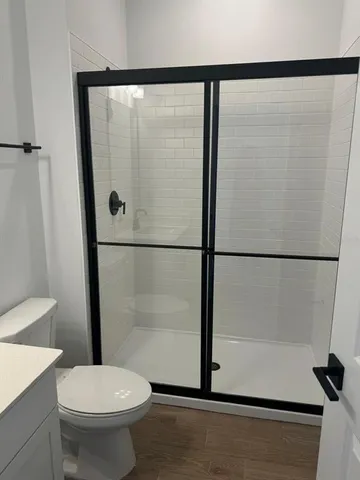 a bathroom with a shower and a toilet