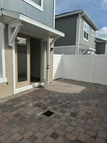 a view of a house with a wooden fence
