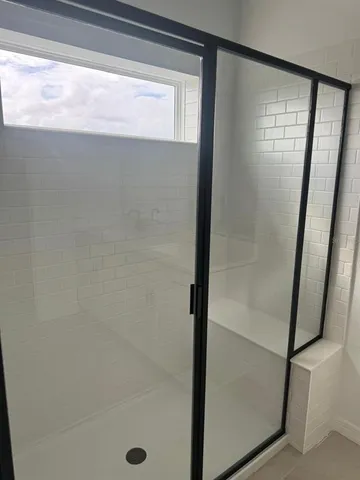 a bathroom with a glass shower door
