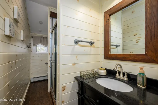a bathroom with a granite countertop sink and a mirror