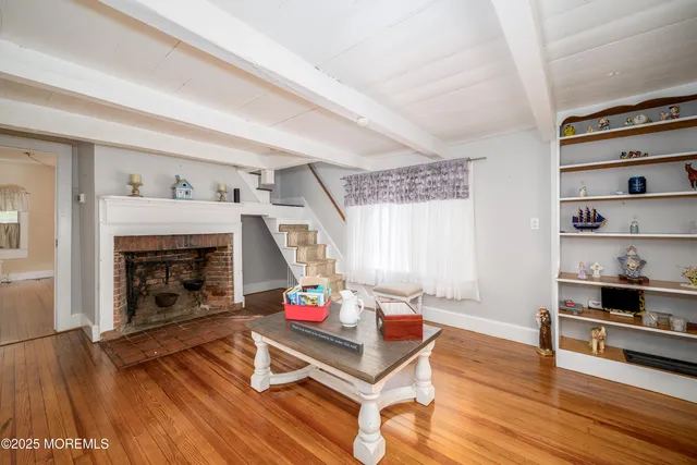 a living room with furniture fireplace and wooden floor