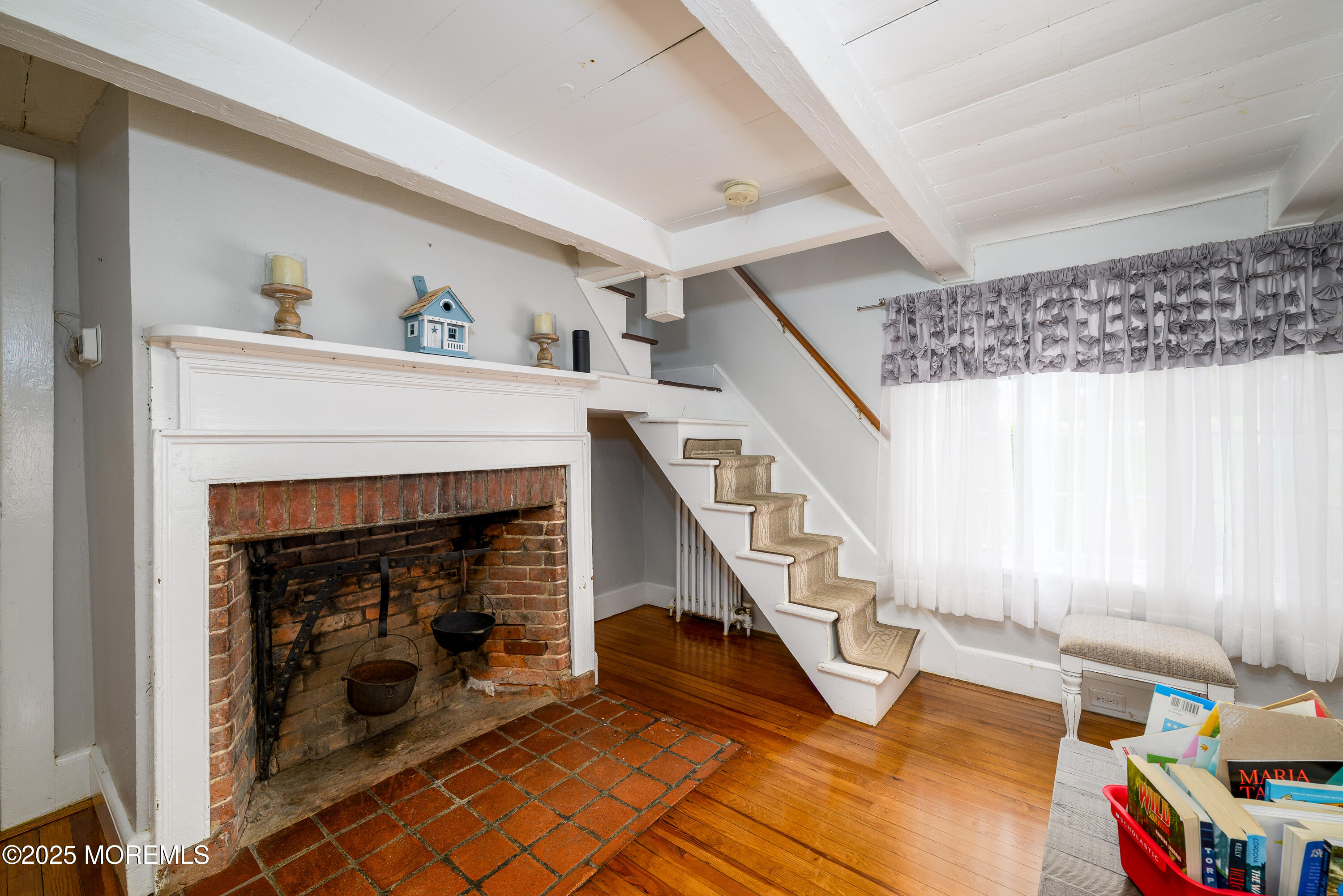 19 Reids Hill Road Morganville, NJ 07751 - Photo 13 of 33 a living room with a fireplace and a book shelf