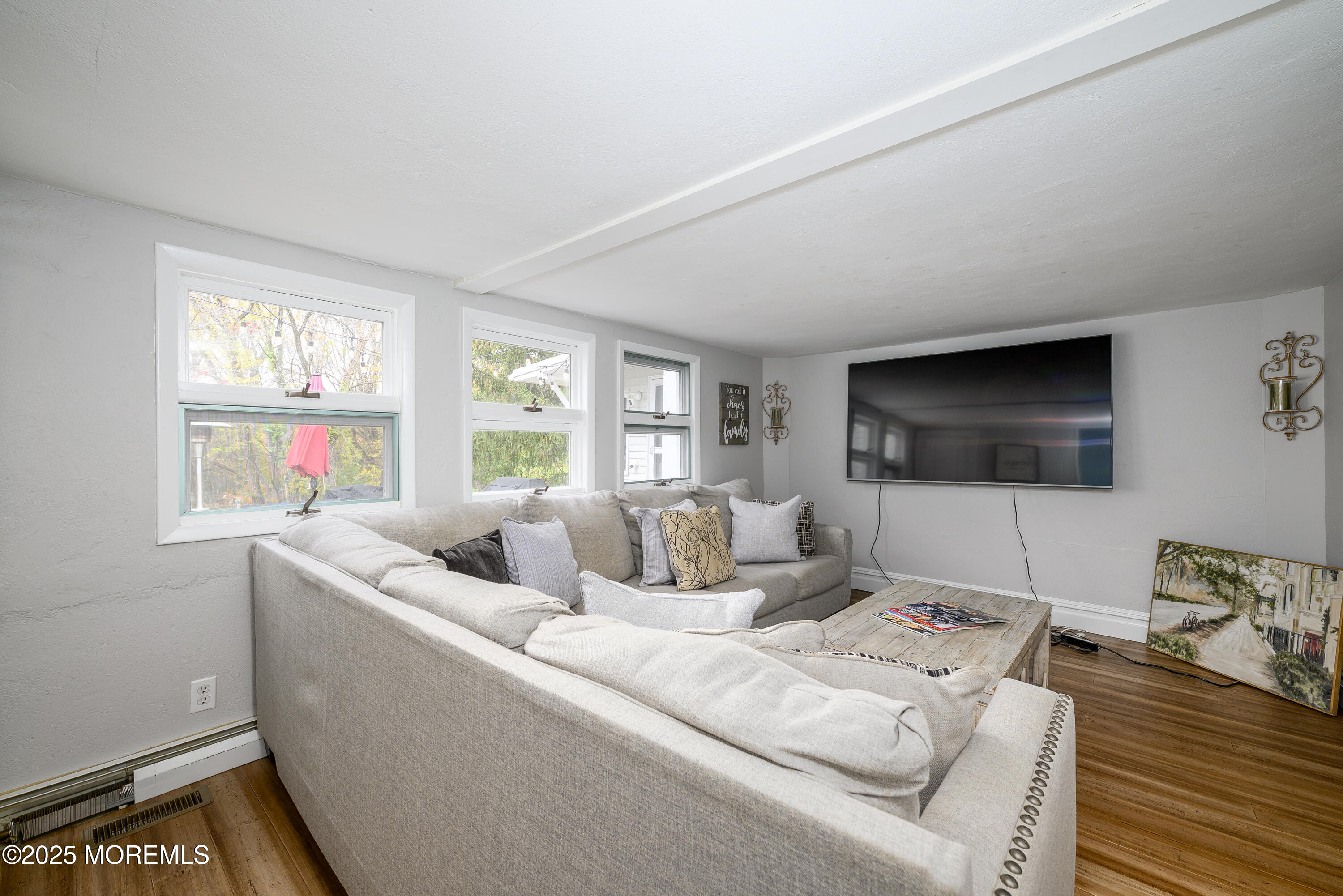 19 Reids Hill Road Morganville, NJ 07751 - Photo 15 of 33 a living room with furniture and a flat screen tv