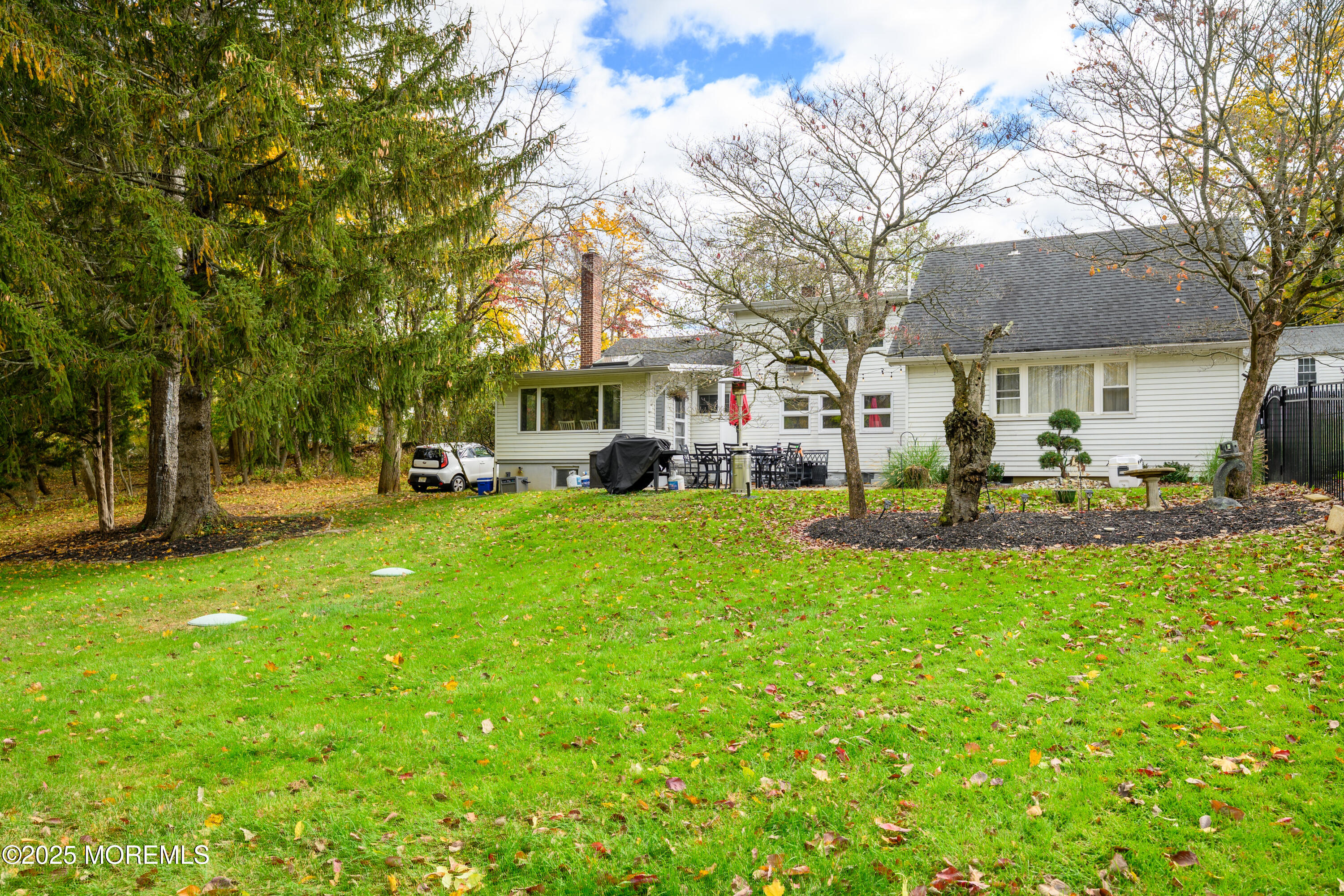 19 Reids Hill Road Morganville, NJ 07751 - Photo 30 of 33 a front view of a building with a garden and trees