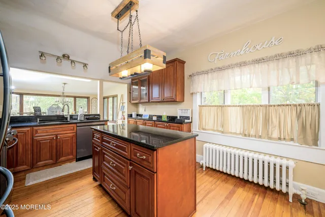a kitchen with stainless steel appliances granite countertop a stove and a sink