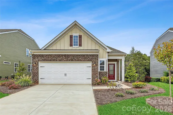 a front view of a house with a garden