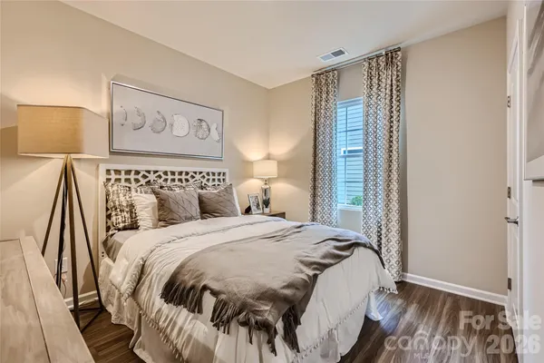 a bedroom with a bed and a painting on the wall