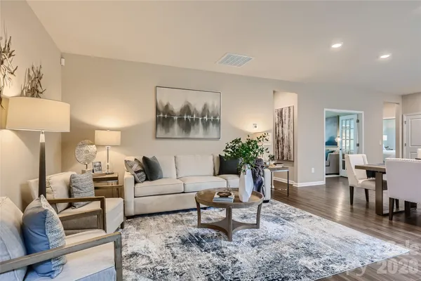 a living room with furniture and a painting on the wall