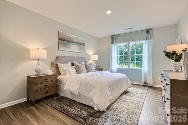 a bed room with a bed and a window