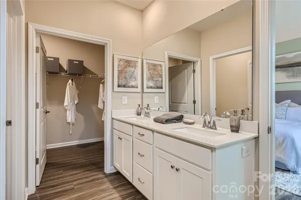 a bathroom with a double vanity sink and mirror