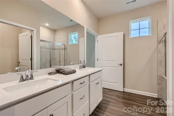 a bathroom with a double vanity sink and mirror