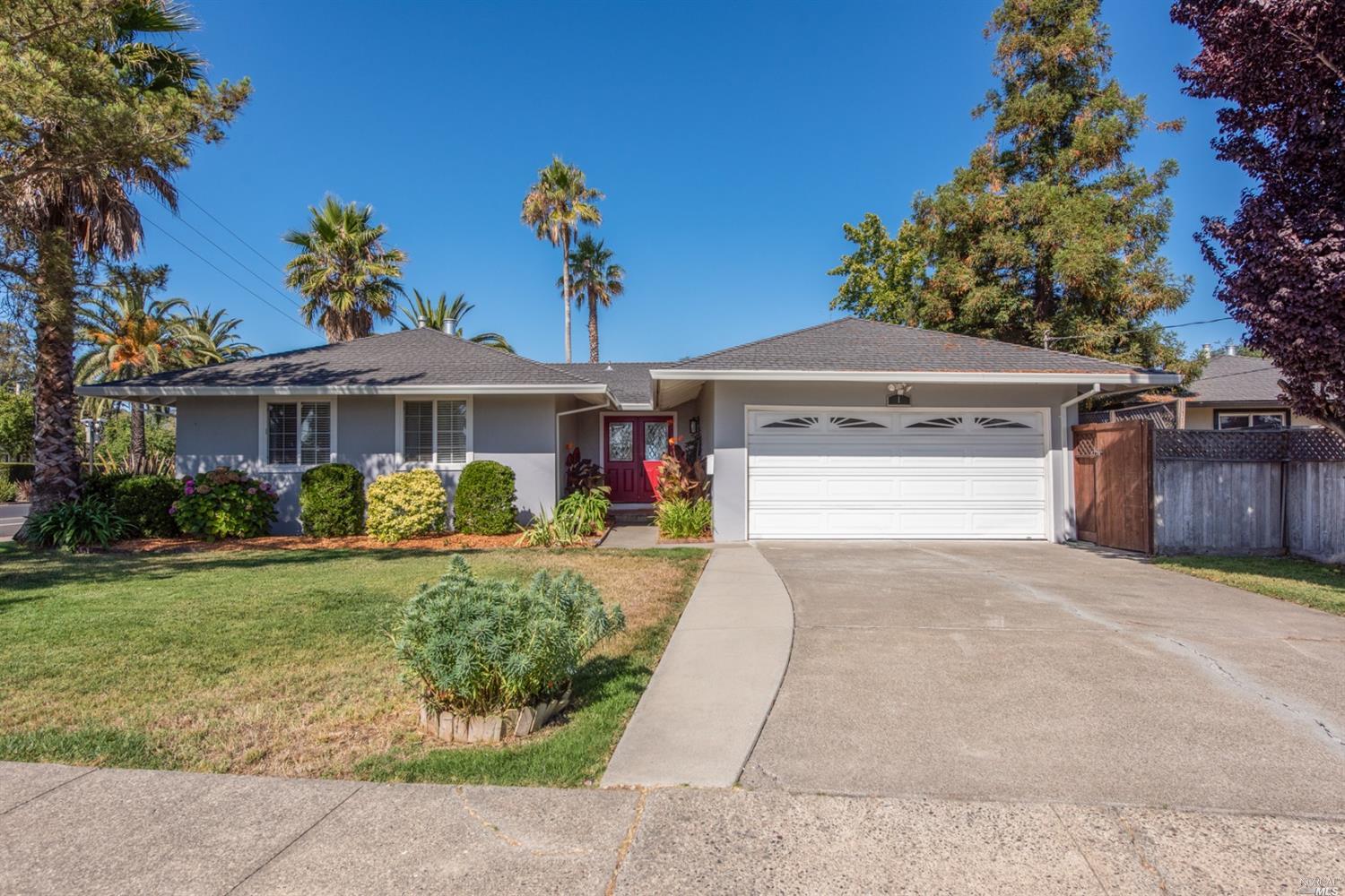 a front view of a house with a yard and a garage
