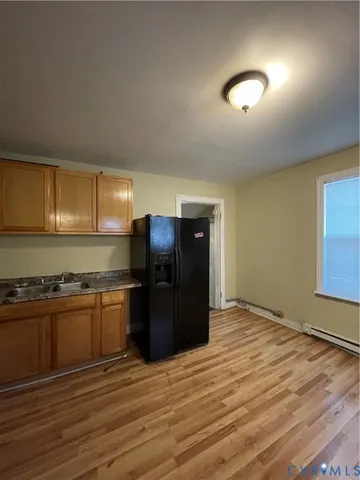 a kitchen with stainless steel appliances granite countertop a refrigerator and a stove top oven