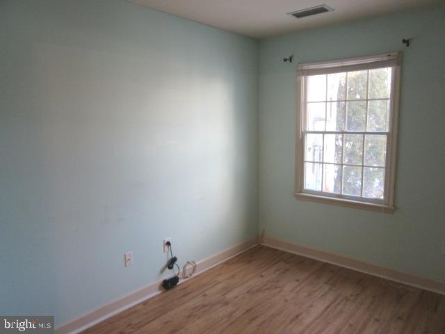 7 East Village Road, Unit 7 Newark, DE 19713 - Photo 27 of 33 an empty room with wooden floor and windows