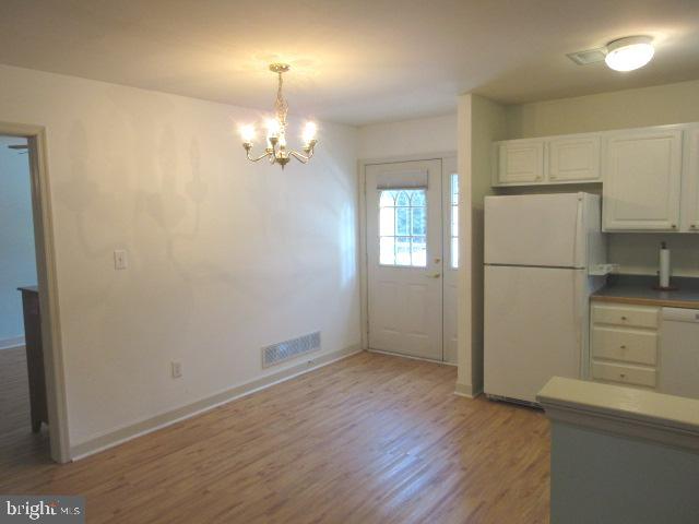 7 East Village Road, Unit 7 Newark, DE 19713 - Photo 8 of 33 wooden floor in an empty room with a window