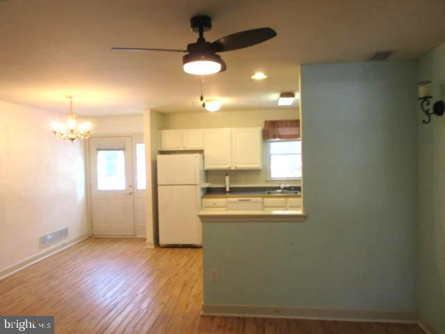 7 East Village Road, Unit 7 Newark, DE 19713 - Photo 10 of 33 a kitchen with a refrigerator a sink dishwasher with a dining table and chairs