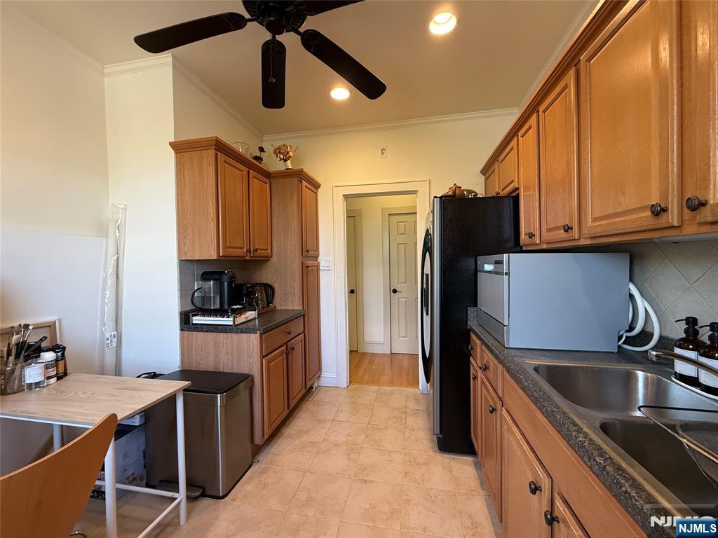 215 Orient Way, Unit C2 Rutherford, NJ 07070 - Photo 11 of 25 a kitchen with kitchen island granite countertop a sink stainless steel appliances and cabinets