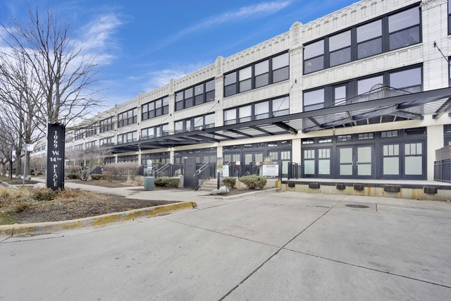a view of building with cars parked
