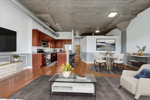 a living room with lots of furniture and kitchen view