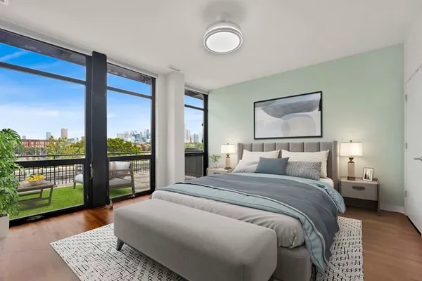a bedroom with a bed and large window