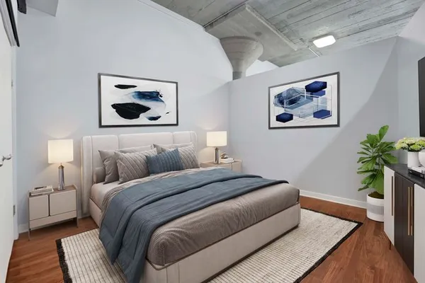 a bedroom with a bed and a potted plant