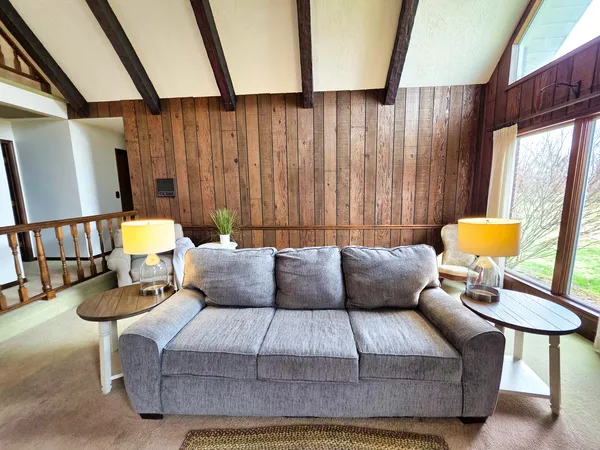 a dining room with furniture a chandelier and wooden floor