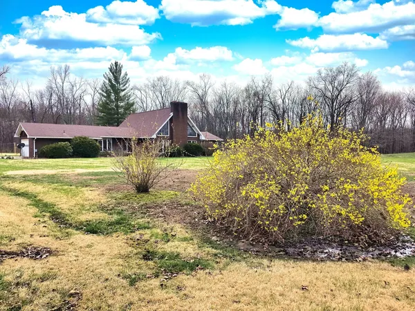 an aerial view of a house with yard