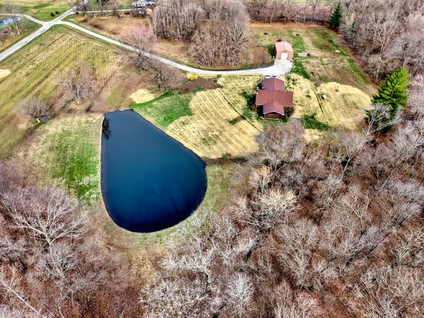 a living room with furniture a fireplace and a large window