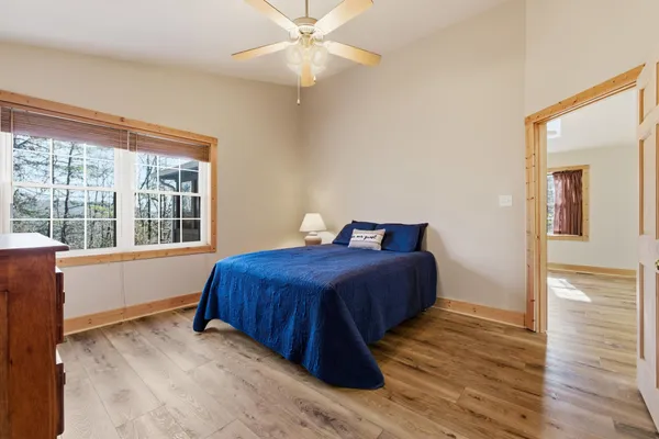 a bedroom with a bed and wooden floor