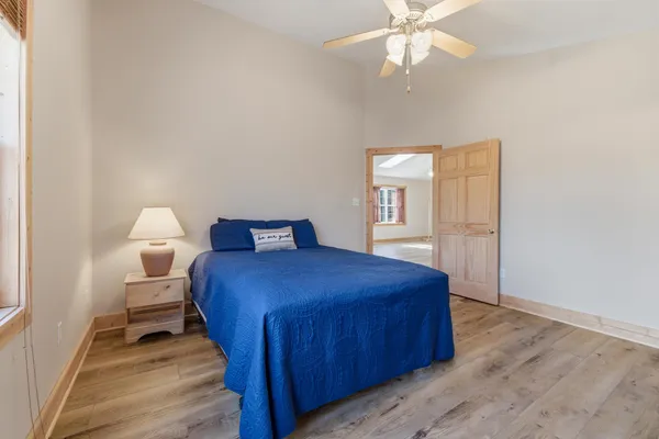 a bedroom with a bed and a window