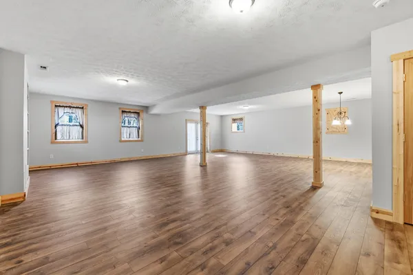 a view of a livingroom with wooden floor and a window