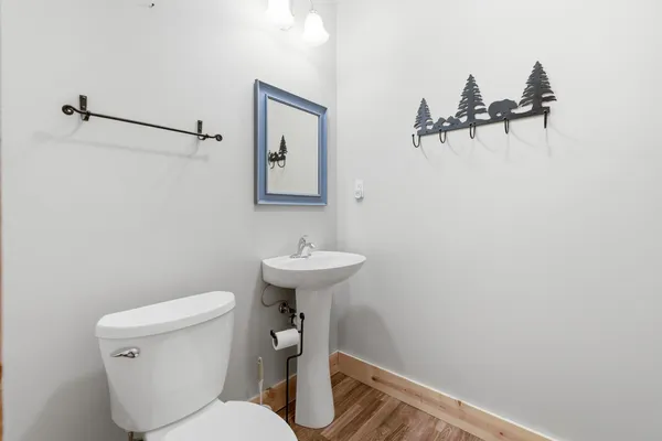 a bathroom with a sink a toilet and mirror