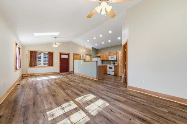 a view of a livingroom with a furniture wooden floor and window
