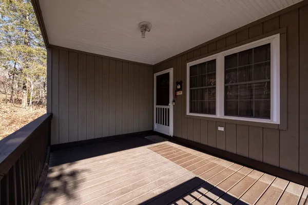 a view of balcony with wooden floor and windows