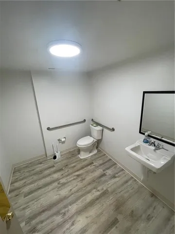 a bathroom with a sink a toilet and a mirror