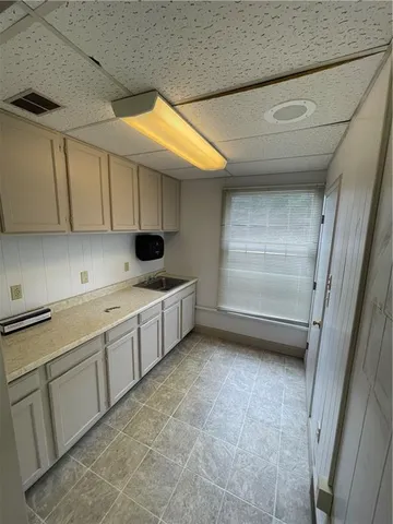 a bathroom with a sink and mirror with toilet