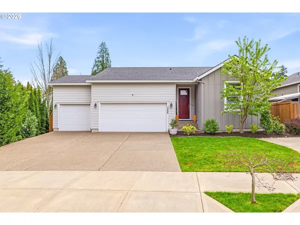 a front view of a house with a yard and garage