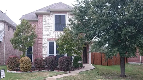 a front view of house with a garden