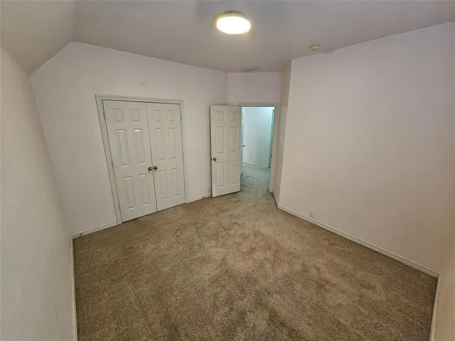 an empty room with closet area