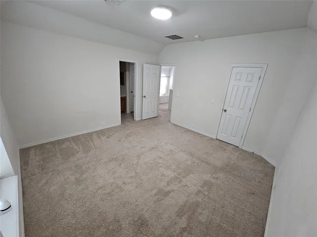 a view of an empty room and a window