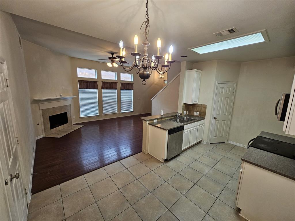 7341 Danbridge Lane Frisco, TX 75035 - Photo 2 of 14 a kitchen with granite countertop a stove and a refrigerator