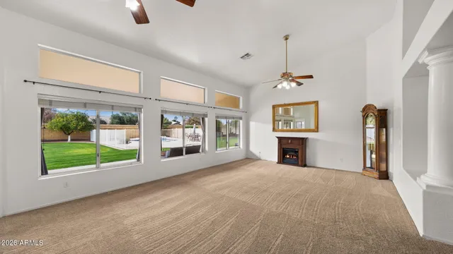 a view of a hallway with wooden floor and a living room
