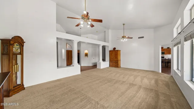 a view of an empty room with a fireplace and a window